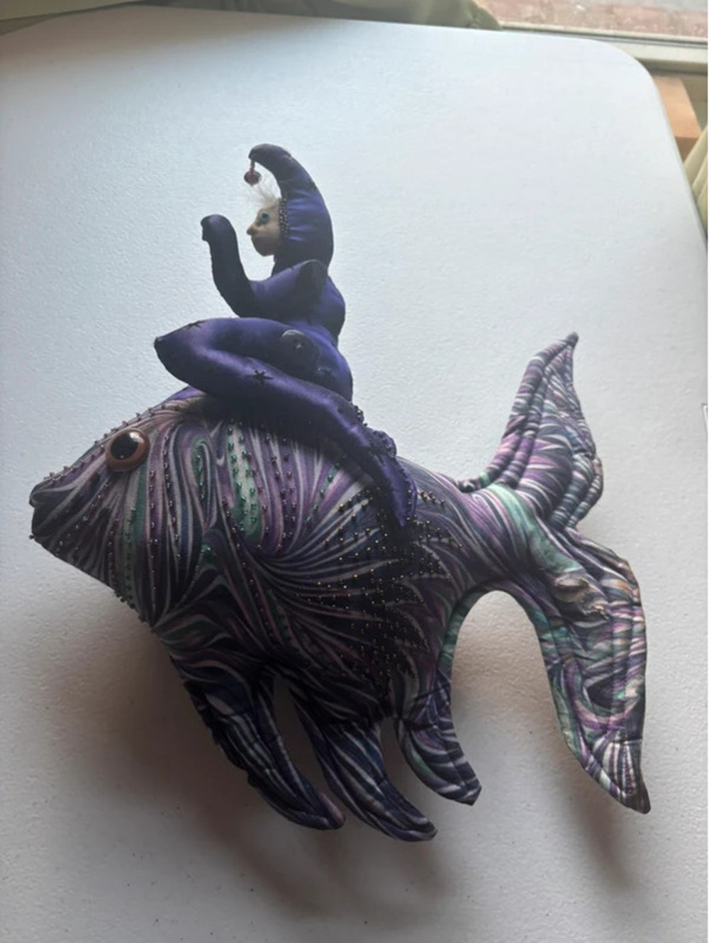 Vintage folk art beaded fish with jester riding on back